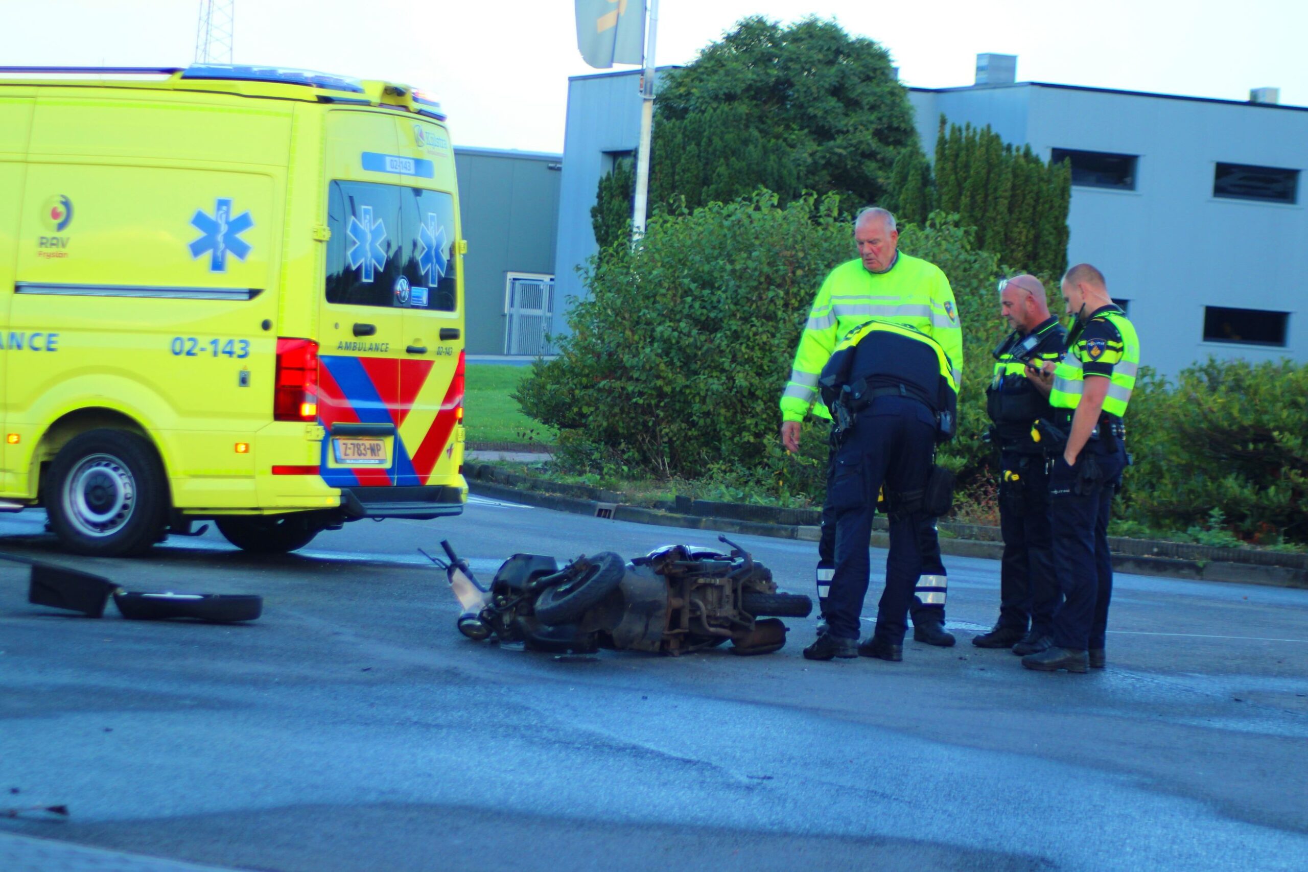 Personenauto rijdt door hek na botsing met scooterrijder in Leeuwarden; scooterrijder gewond